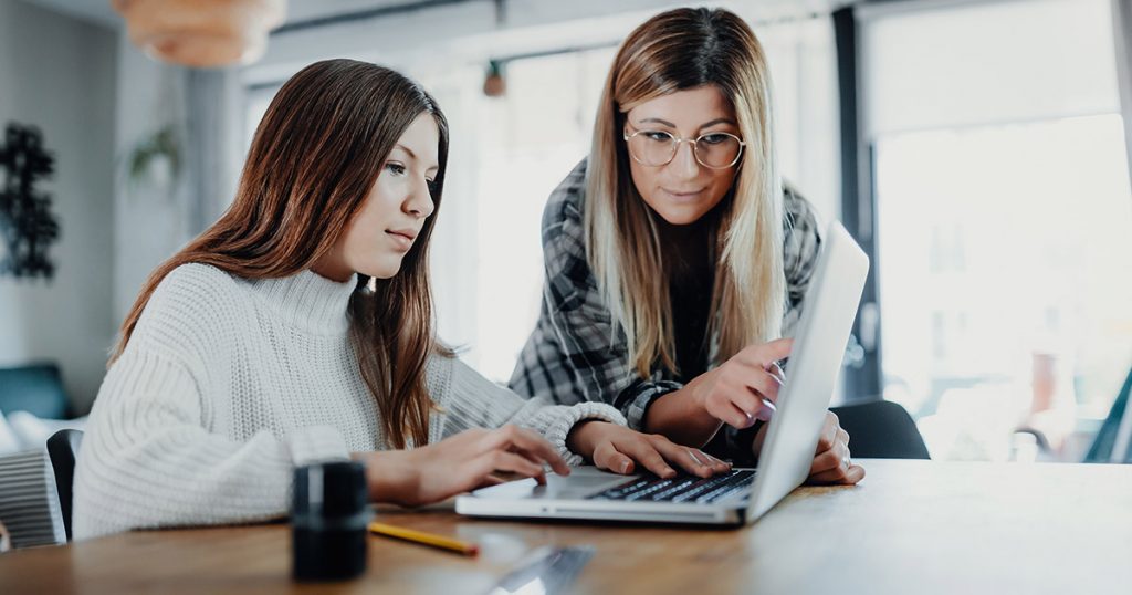 Photo of Mother and Daughter doing home schooling
