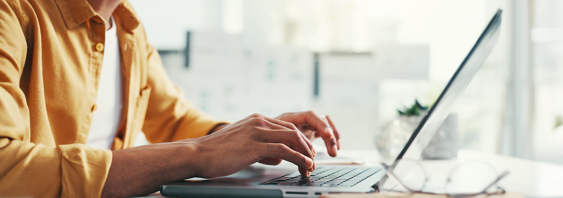 Person typing at an open laptop