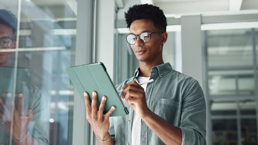 Person checking tablet for compliance topics